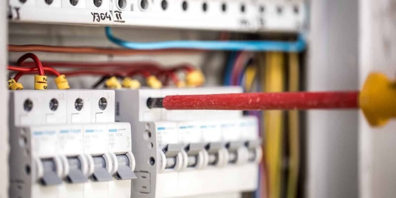 Man, an electrical technician working in a switchboard with fuses. Installation and connection of electrical equipment. Professional with tools in hand. concept of complex work, space for text. SSUCv3H4sIAAAAAAAEAI1Ry27CMBC8V+o/RD4TKSGBEP6gh0q9ox429kIsjBf50Qoh/r12jCufqt68M+vZnZ3760tVsQms5Gxf3WMVaqmUt86Ak6QD3KyeuEEt0JQICunISFAlOIHjs4YLBlB7pSL8WEhmHThv0cZhT4iDw1PQSOCvRNrokOoqEwsZfgSKfSBdFbJVwVg/ReZdWo5KgUbylmX+sfpD7E2LaDk6+b9genxm33BCzW+LtcKyQYWQLB9SKzt/OzSX8gjghaTC/xdxULGhK5SuRnKpT8U3cvOSR/7GyWtn4gos22CK6AqTimEcgyZmfAZrQ7vIeDGIh1PQpZijyS0GnqpMhMxi2Xbrdtf3m75th22za7qR5ZyJn6UoLaboZxkocytwGTdgXTMN62431DiOTd23sK3HAYd6PTTIjx30/LgJh3/8ADyRAdGxAgAA
